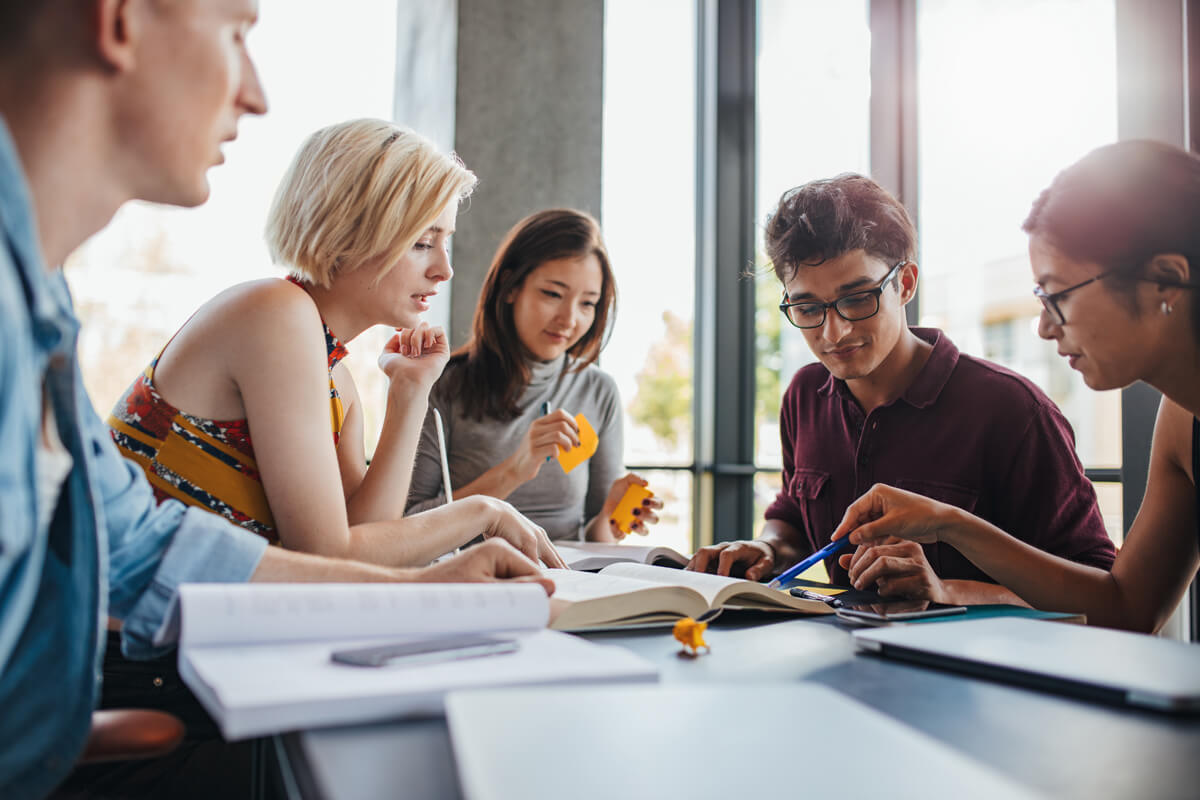 Diverse group of students studying at library